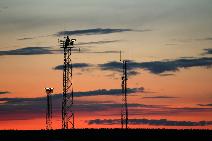 Photo of radio towers and sunset