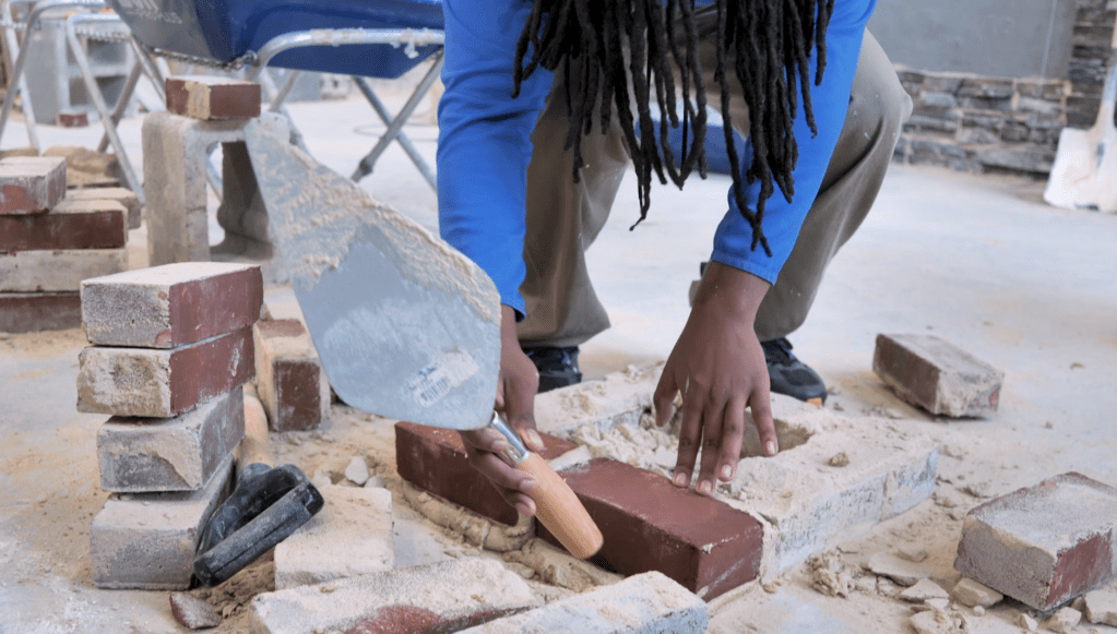 A Carver Vo-Tech student practices masonry skills.