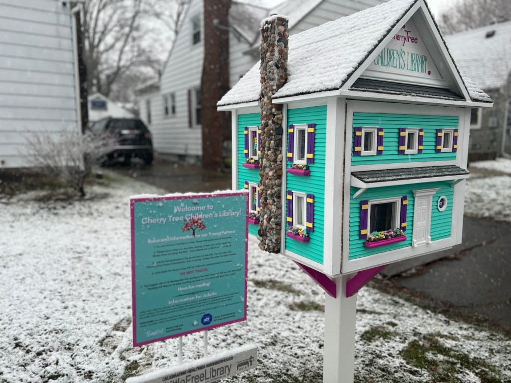 Nancy Vogl and David Strange's Little Free Library proudly proclaims that it's protected by ADT.