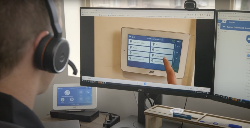An ADT Remote Assistance technician views a customer's control panel through their cellphone camera