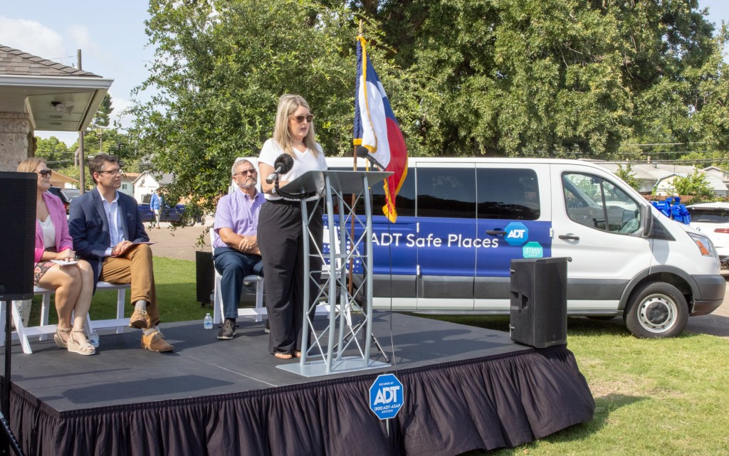Michelle Flores, the founder of All Things Made New, speaks at an event announcing the group as an ADT Safe Places partner.